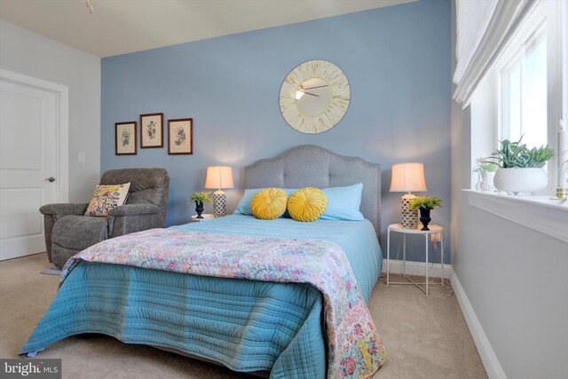 carpeted bedroom featuring baseboards