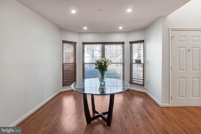 dining area with recessed lighting, plenty of natural light, baseboards, and wood finished floors