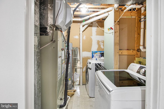 laundry room featuring laundry area, washer and clothes dryer, and tile patterned floors