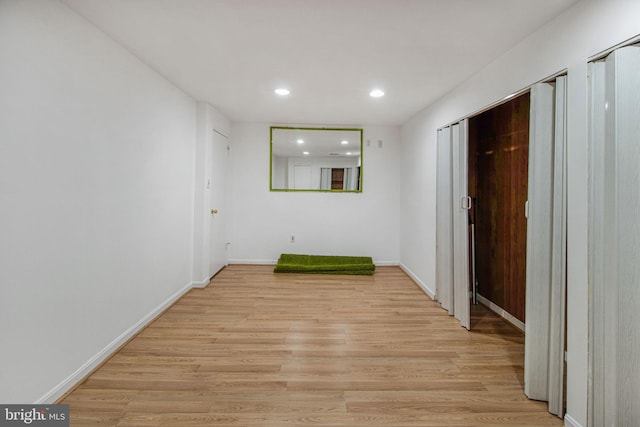 unfurnished room featuring baseboards, recessed lighting, and light wood-style floors