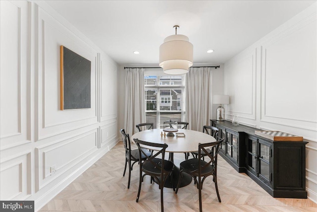 dining room with recessed lighting and a decorative wall