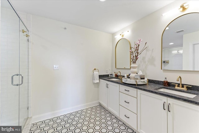 full bathroom with a stall shower, visible vents, a sink, and double vanity