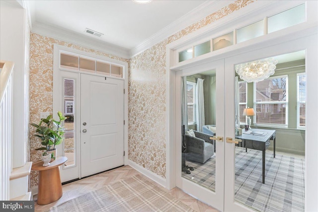 foyer featuring ornamental molding, french doors, and wallpapered walls