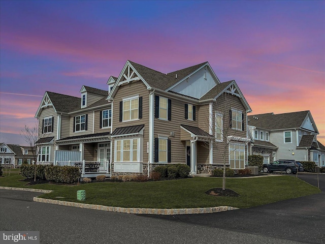 view of front of house featuring a porch, driveway, and a front lawn