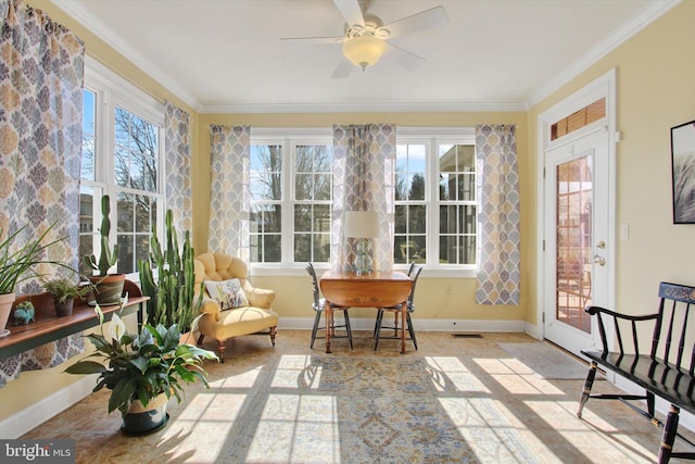 sunroom featuring a ceiling fan, visible vents, and a healthy amount of sunlight