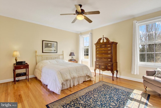 bedroom featuring light wood-style flooring, ornamental molding, and baseboards