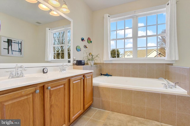 bathroom with double vanity, plenty of natural light, a sink, and tile patterned flooring