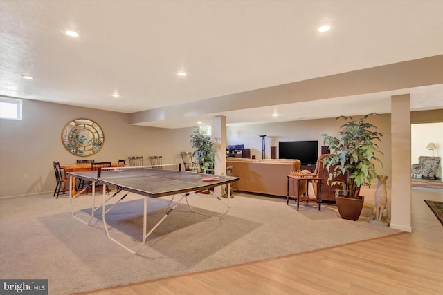 recreation room featuring baseboards, wood finished floors, and recessed lighting