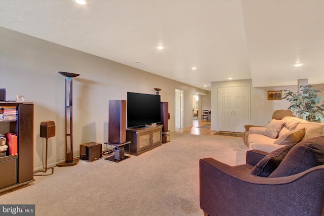 living area with recessed lighting and light colored carpet