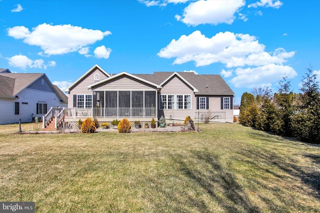 back of house featuring a sunroom and a yard