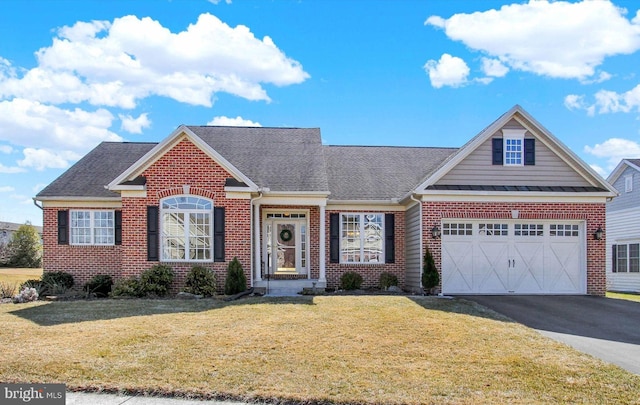 view of front facade featuring driveway, a garage, a front lawn, and brick siding