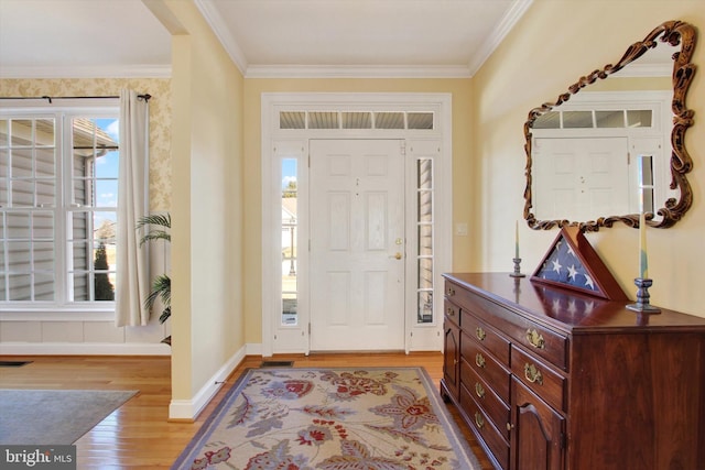 entrance foyer with light wood finished floors, visible vents, baseboards, and crown molding