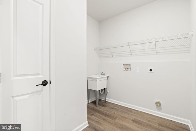 washroom with laundry area, washer hookup, wood finished floors, baseboards, and electric dryer hookup