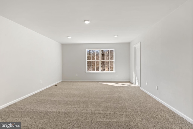 carpeted spare room with baseboards