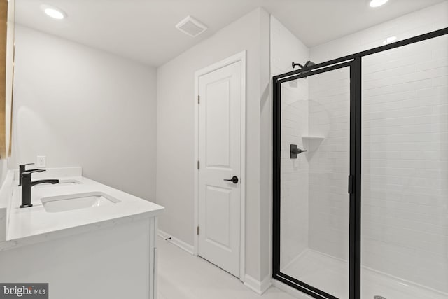 bathroom with a stall shower, visible vents, a sink, and recessed lighting