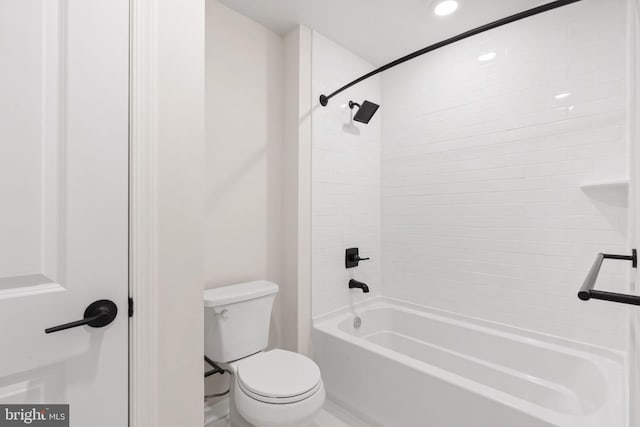 bathroom featuring recessed lighting, bathtub / shower combination, and toilet