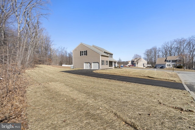 exterior space with driveway and an attached garage