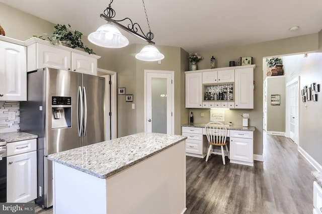 kitchen featuring white cabinets, stainless steel fridge with ice dispenser, dark wood-style floors, decorative light fixtures, and light stone countertops