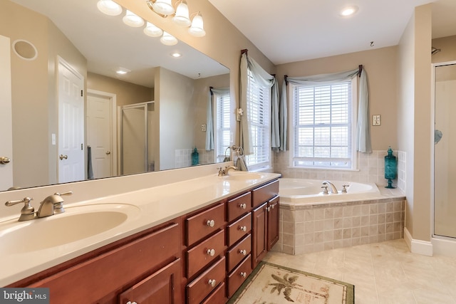 full bathroom featuring double vanity, a stall shower, a garden tub, tile patterned flooring, and a sink