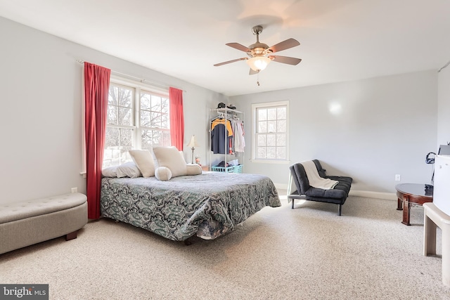 bedroom with a ceiling fan and multiple windows