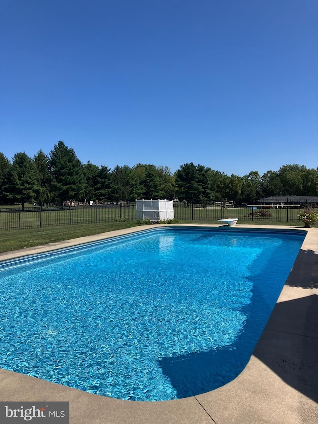 view of pool with a fenced in pool and fence