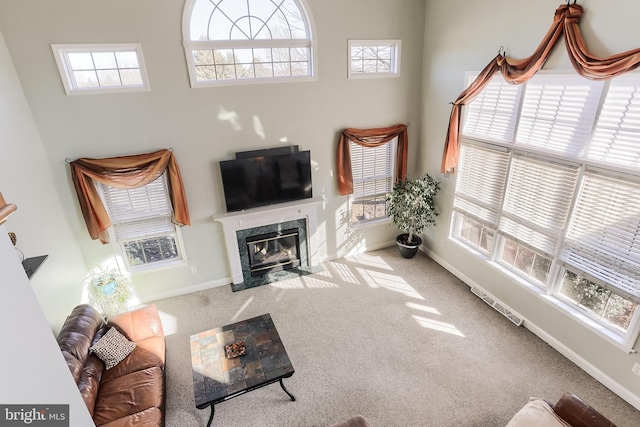 living area featuring carpet, a fireplace, and baseboards