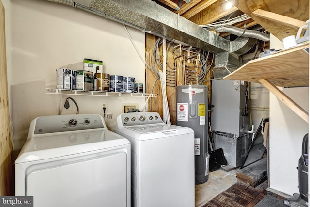 clothes washing area with laundry area, water heater, washer and clothes dryer, and heating unit