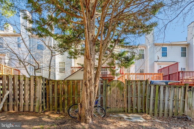 view of yard with a fenced backyard and a gate