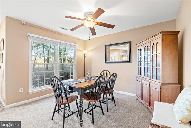 dining area with light carpet, visible vents, ceiling fan, and baseboards