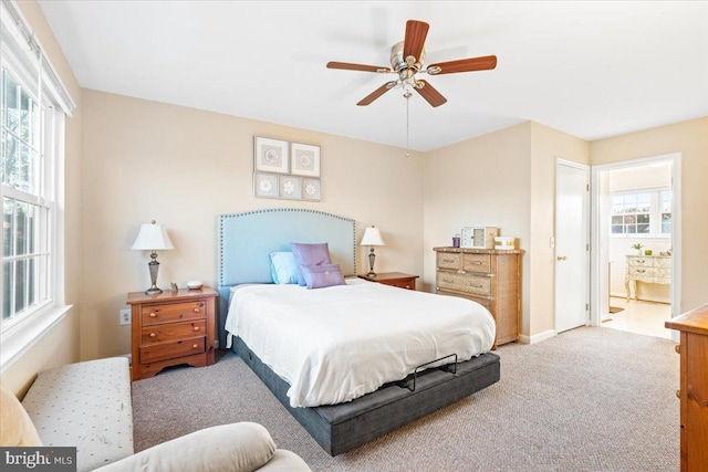 bedroom featuring baseboards, carpet floors, connected bathroom, and a ceiling fan