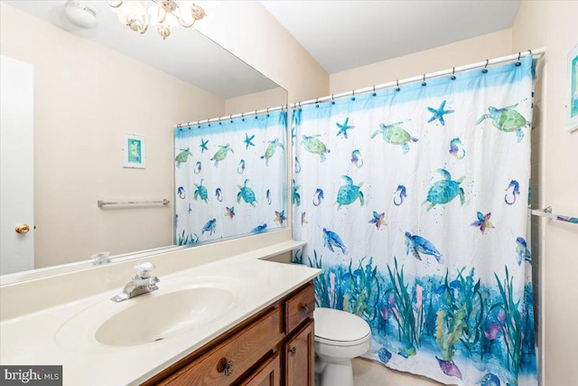 bathroom with vanity, a shower with shower curtain, and toilet