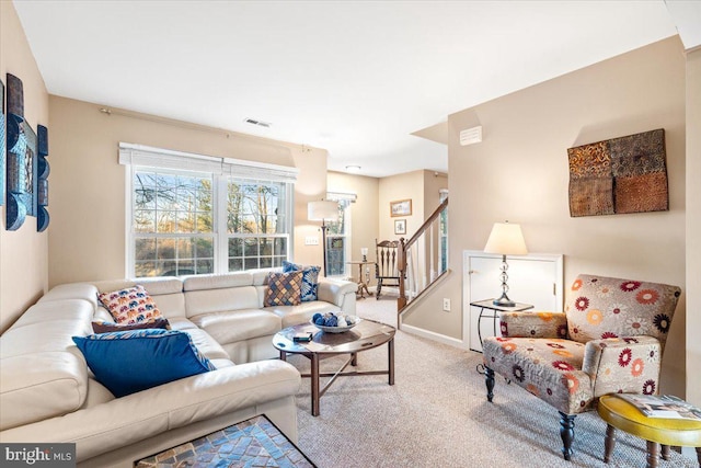 living area with stairway, carpet, and baseboards