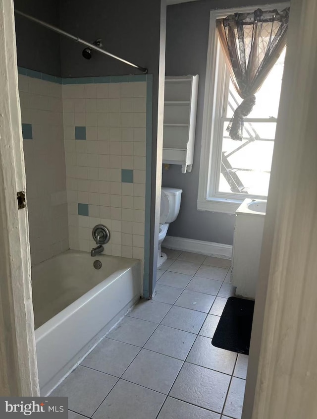 bathroom with  shower combination, baseboards, toilet, and tile patterned floors