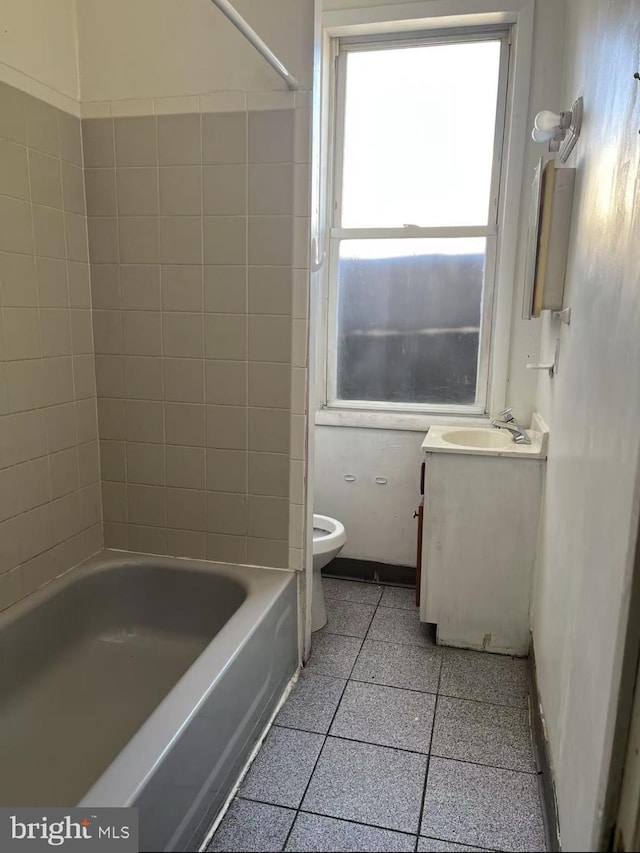 bathroom featuring toilet, baseboards, and vanity