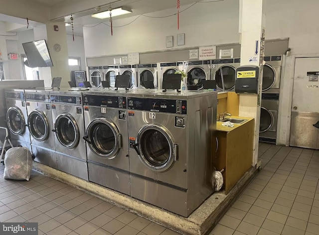 community laundry room featuring stacked washer and dryer, tile patterned floors, and independent washer and dryer