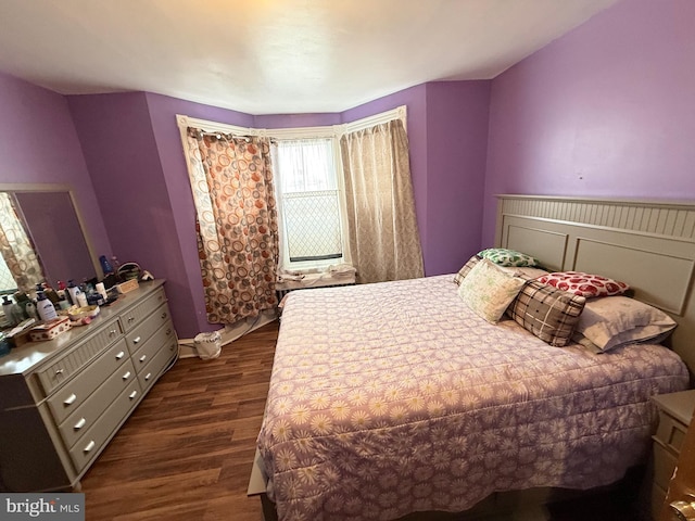 bedroom with dark wood-type flooring