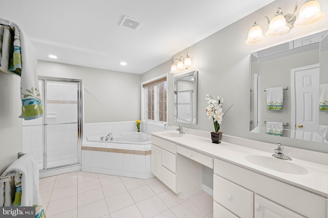 full bathroom with double vanity, a garden tub, a shower stall, and a sink