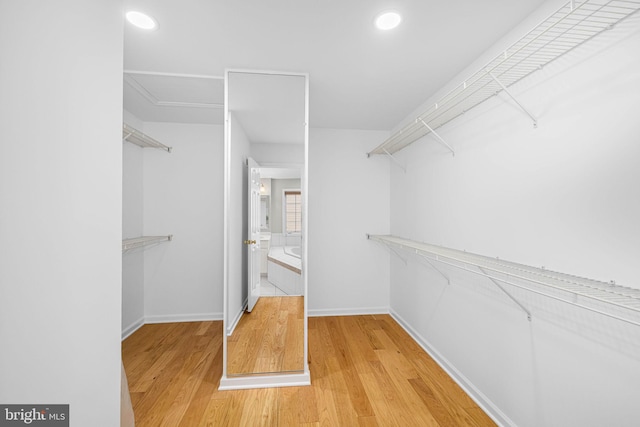 spacious closet with wood finished floors