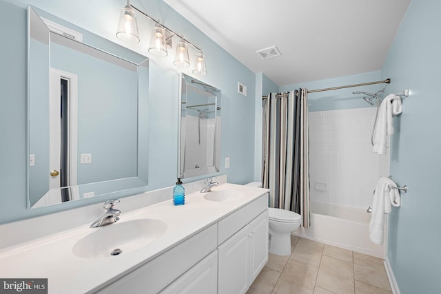 bathroom featuring shower / bath combo with shower curtain, visible vents, a sink, and tile patterned floors