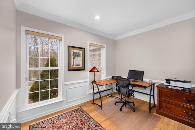 home office featuring a wainscoted wall, crown molding, and light wood-style flooring