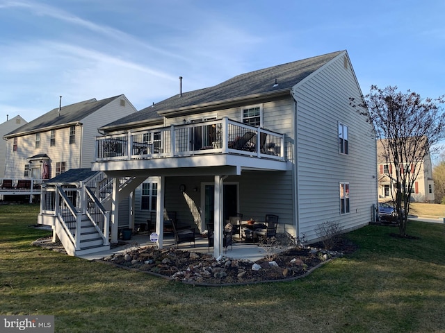 back of property featuring a deck, a lawn, and a patio