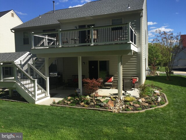 rear view of property with stairs, a patio, a yard, and a shingled roof