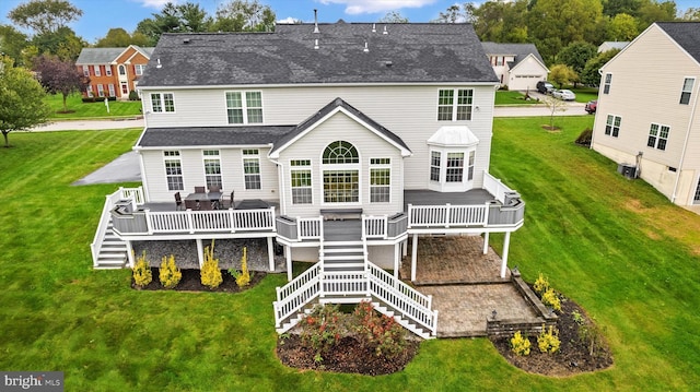 back of house featuring a wooden deck, stairs, a shingled roof, and a yard