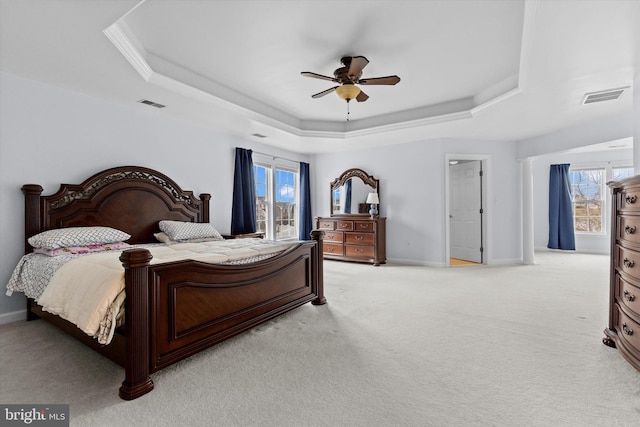 bedroom with baseboards, visible vents, and a raised ceiling