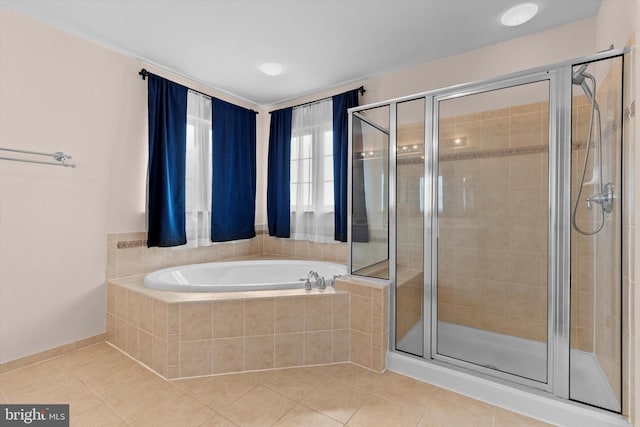 full bathroom with a stall shower, a bath, and tile patterned floors