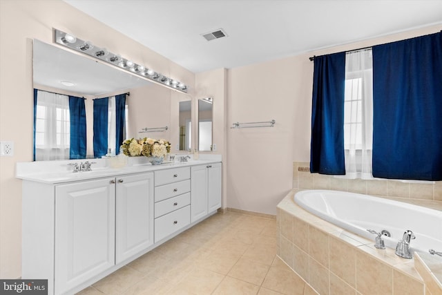 full bathroom with a garden tub, double vanity, visible vents, a sink, and tile patterned floors