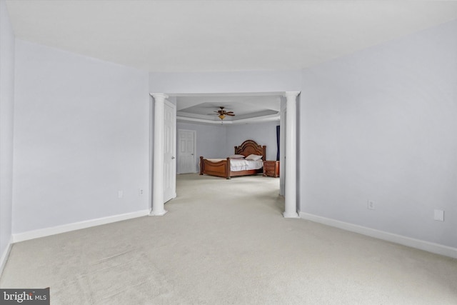 bedroom featuring carpet floors, baseboards, and ornate columns