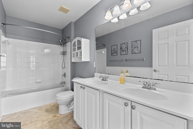 full bathroom featuring visible vents, a sink, toilet, and tub / shower combination