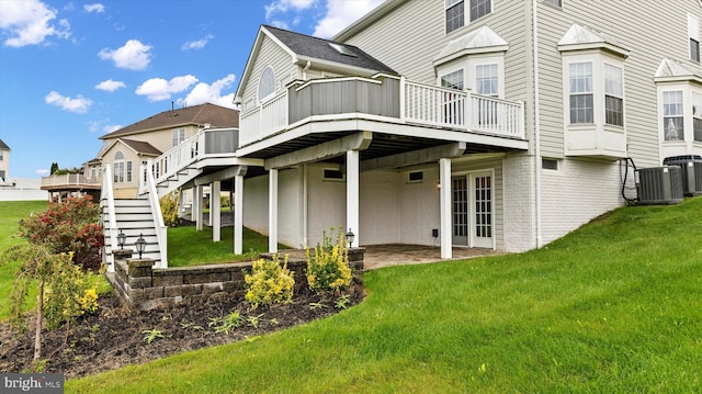 back of house featuring a yard, stairway, a wooden deck, and central air condition unit