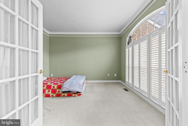 bedroom with baseboards, carpet, visible vents, and crown molding